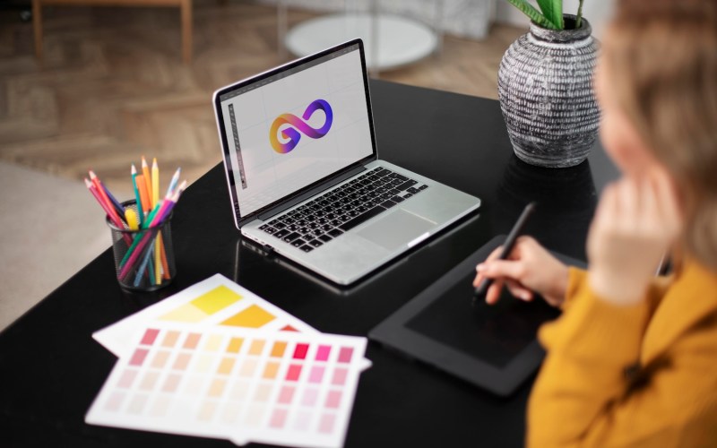 female-logo-designer-working-her-tablet-connected-laptop